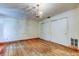 Bedroom with wood floors, chandelier, and white closets at 9918 Davis Rd, Tampa, FL 33637