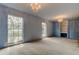Blue bedroom featuring two windows, built in wardrobes and chandelier-style lighting at 9918 Davis Rd, Tampa, FL 33637