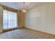 Bright dining area with modern light fixture and large window with sheer curtains at 9918 Davis Rd, Tampa, FL 33637