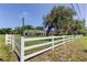 Well-maintained front yard with a white fence showcasing the property's boundary at 9918 Davis Rd, Tampa, FL 33637