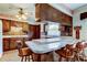 Kitchen boasts breakfast bar, wood cabinets, brick backsplash, and seamlessly connects to other rooms at 9918 Davis Rd, Tampa, FL 33637