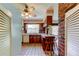 Functional kitchen with wood cabinets, brick accents, and vintage charm at 9918 Davis Rd, Tampa, FL 33637