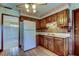 Traditional kitchen features wood cabinets, a white refrigerator, and brick-style backsplash at 9918 Davis Rd, Tampa, FL 33637