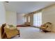 Cozy living room featuring comfortable seating and abundant natural light from large windows at 9918 Davis Rd, Tampa, FL 33637