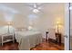 A cozy bedroom with hardwood floors, a floral comforter, and dual bedside tables at 1 Beach Se Dr # 2011, St Petersburg, FL 33701