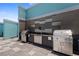 Outdoor kitchen with stainless steel gas grills and a sink at 1 Beach Se Dr # 2011, St Petersburg, FL 33701