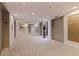 A condo hallway with neutral carpet, multiple elevators, and decorative wall art at 1 Beach Se Dr # 2011, St Petersburg, FL 33701