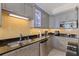 Modern kitchen features granite countertops, gray cabinets, tiled flooring and stainless steel appliances at 1 Beach Se Dr # 2011, St Petersburg, FL 33701