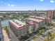Aerial view of waterfront condos, neighborhood, and a glimpse of the distant city skyline at 105 Island Way # 126, Clearwater Beach, FL 33767