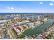 Aerial view of a waterfront condo community offering a pool, tennis court, and dock at 105 Island Way # 126, Clearwater Beach, FL 33767