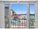 Enclosed balcony overlooking the community pool and waterfront with views of the harbor at 105 Island Way # 126, Clearwater Beach, FL 33767
