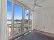 Enclosed balcony with water views, fan, and textured walls at 105 Island Way # 126, Clearwater Beach, FL 33767
