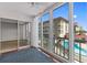 Enclosed balcony overlooking the pool with sliding glass doors at 105 Island Way # 126, Clearwater Beach, FL 33767