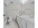 Clean bathroom with white cabinets, countertop, and tile flooring at 105 Island Way # 126, Clearwater Beach, FL 33767