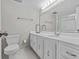 Bright bathroom features a large vanity and a toilet at 105 Island Way # 126, Clearwater Beach, FL 33767