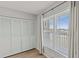 Bright bedroom with wood floors, large window, and closet with white, shuttered doors at 105 Island Way # 126, Clearwater Beach, FL 33767