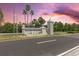 A stone sign reads 'Island Estates', with palm trees beneath a colorful sunset at 105 Island Way # 126, Clearwater Beach, FL 33767