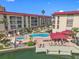 A waterfront condo community featuring a pool, dock, and lounging area with mature landscaping at 105 Island Way # 126, Clearwater Beach, FL 33767