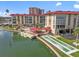 A waterfront condo featuring a pool, dock, and shuffleboard court with mature landscaping at 105 Island Way # 126, Clearwater Beach, FL 33767