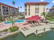Condominiums featuring a waterfront pool, dock, outdoor lounging area with covered pergola at 105 Island Way # 126, Clearwater Beach, FL 33767