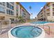 Community hot tub and pool, surrounded by lush landscaping, create a serene and inviting atmosphere for residents to enjoy at 105 Island Way # 126, Clearwater Beach, FL 33767
