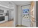 Charming kitchen features stainless steel appliances, white cabinetry, and wood floors at 105 Island Way # 126, Clearwater Beach, FL 33767