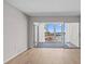 Bright living room featuring hardwood floors and sliding glass doors to the balcony with harbor view at 105 Island Way # 126, Clearwater Beach, FL 33767