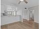 Bright living room with wood floors, and a view of the open kitchen area at 105 Island Way # 126, Clearwater Beach, FL 33767