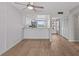 Open concept living space featuring wood flooring, a ceiling fan, and a view into the kitchen area at 105 Island Way # 126, Clearwater Beach, FL 33767