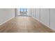 Bright and airy living area featuring wood floors and sliding glass doors to a private balcony at 105 Island Way # 126, Clearwater Beach, FL 33767