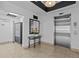 A clean lobby area with a mirror and table with a flower arrangement and an elevator at 105 Island Way # 126, Clearwater Beach, FL 33767