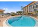 Community pool and lounge chairs offer space for relaxation and fun at 105 Island Way # 126, Clearwater Beach, FL 33767