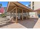 Open air poolside pavilion featuring a dining area with tables and chairs, and lounge chairs for relaxing by the pool at 105 Island Way # 126, Clearwater Beach, FL 33767