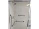 Bathroom shower stall with safety bars and tiled walls at 11541 Orleans Ln, Port Richey, FL 34668