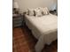Cozy bedroom featuring warm neutral tones and comfortable bedding on top of decorative tile flooring at 11541 Orleans Ln, Port Richey, FL 34668
