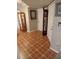 Foyer with tile flooring, grandfather clock, and decor at 11541 Orleans Ln, Port Richey, FL 34668