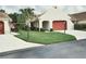 Charming single-story home with well-manicured lawn and a red garage door creating curb appeal at 11541 Orleans Ln, Port Richey, FL 34668