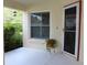 Inviting covered front porch with a potted plant and window, creating a cozy outdoor space at 11541 Orleans Ln, Port Richey, FL 34668