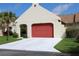 Attached garage with a red door and ample driveway space, perfect for parking and curb appeal at 11541 Orleans Ln, Port Richey, FL 34668