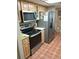 Kitchen featuring stainless steel appliances, including refrigerator, range, and microwave at 11541 Orleans Ln, Port Richey, FL 34668