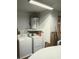 Laundry room featuring a washing machine, dryer, and water heater at 11541 Orleans Ln, Port Richey, FL 34668