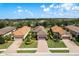Aerial view of well-maintained homes with tile roofs, landscaping, and community feel at 11551 Callisia Dr, Odessa, FL 33556