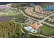 An aerial view shows the community layout with pools, tennis courts, and scenic water views at 11551 Callisia Dr, Odessa, FL 33556