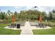 A bocce ball court with picnic tables and umbrellas provide residents a place to socialize at 11551 Callisia Dr, Odessa, FL 33556