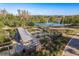 Charming community garden features raised beds, a shaded pavilion, and a picturesque windmill by the pond at 11551 Callisia Dr, Odessa, FL 33556