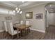 Stylish dining area featuring modern lighting, wood floors, neutral walls, and an adjacent hallway entrance at 11551 Callisia Dr, Odessa, FL 33556