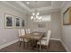 Elegant dining room with modern lighting, wood floors, neutral walls, and ample space for Gathering gatherings at 11551 Callisia Dr, Odessa, FL 33556