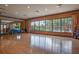 A bright fitness center features wood floors, a mirrored wall, and large windows with views of the pool and lounge area at 11551 Callisia Dr, Odessa, FL 33556