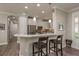 Kitchen with stainless steel appliances, white cabinetry, and a breakfast bar with seating at 11551 Callisia Dr, Odessa, FL 33556