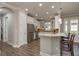 Kitchen with stainless steel appliances, white cabinetry, and a breakfast bar with seating at 11551 Callisia Dr, Odessa, FL 33556
